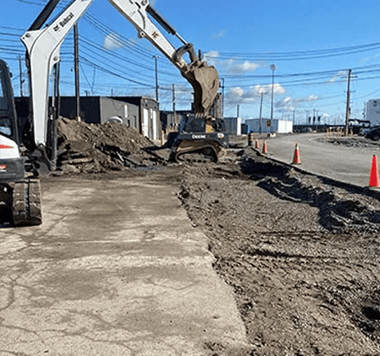 Excavator working on road construction site for infrastructure projects.