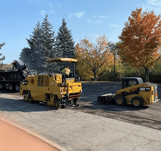 Construction machinery paving asphalt on a road.