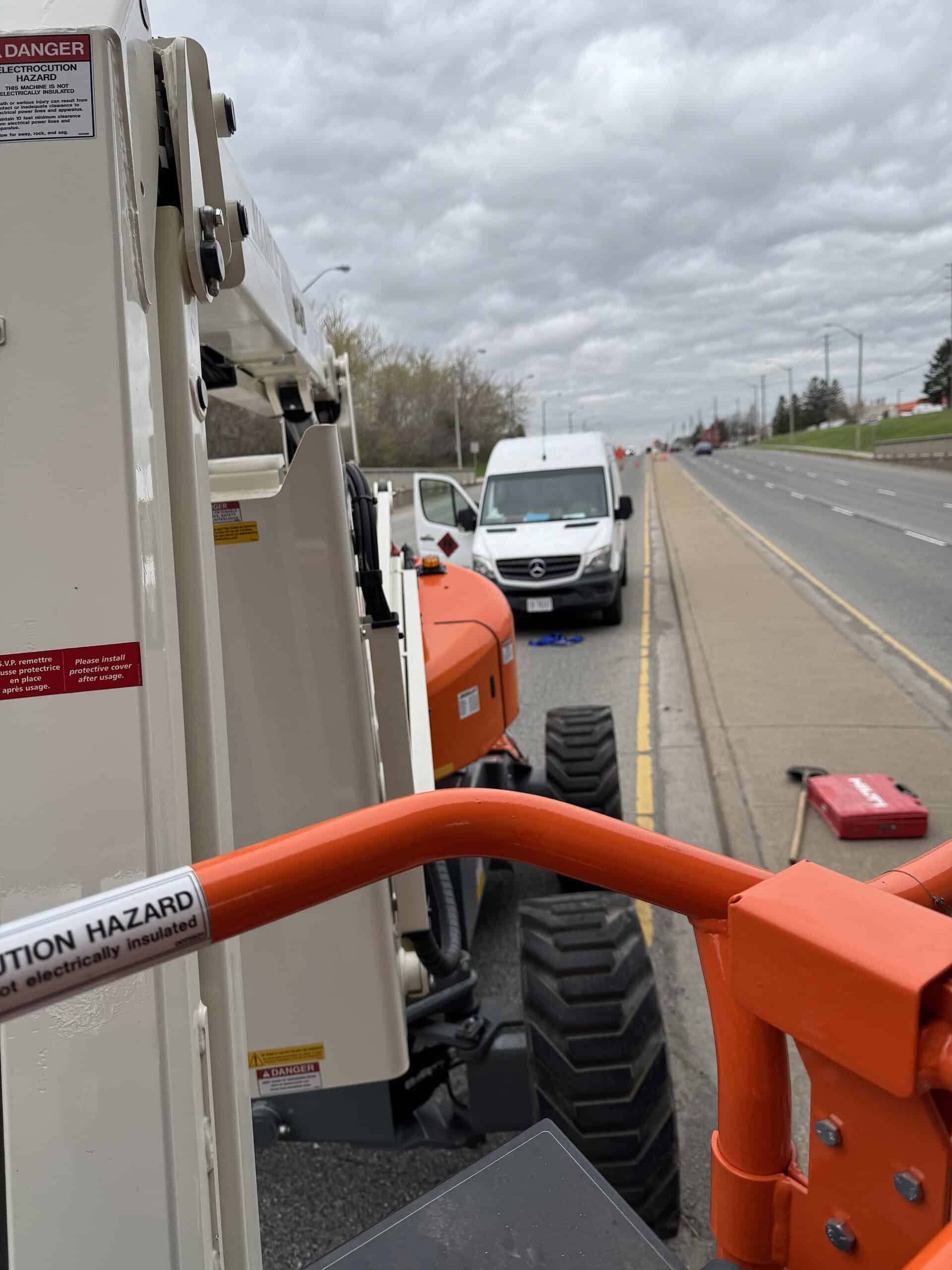 Construction machinery on roadside for infrastructure work.