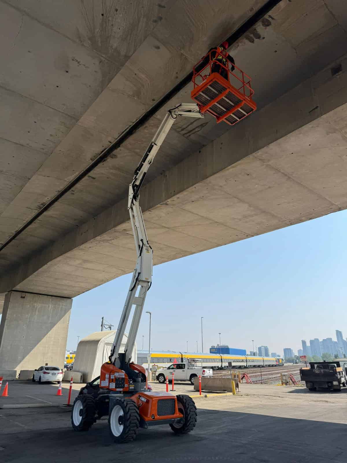 Bridge inspection lift under concrete bridge structure.